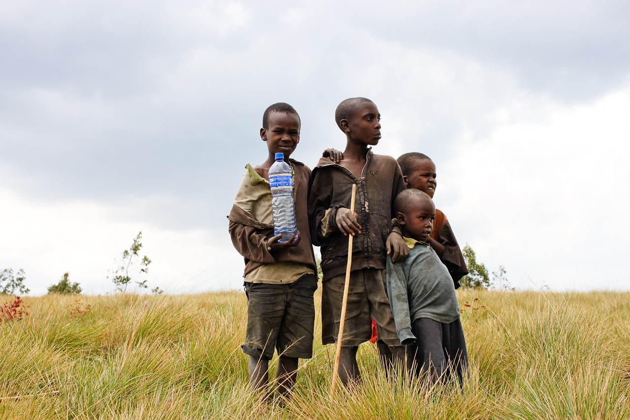 African children holding a bottle of water